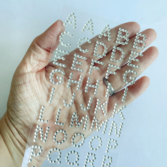 15mm Self-Adhesive Silver Diamante Alphabet Stickers shown in hand for size reference – Perfect for Card Making, Scrapbooking and Wedding Invitations