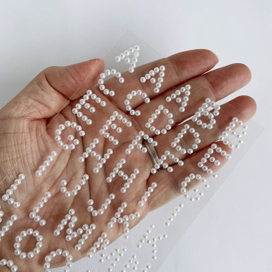 15mm Self-Adhesive White Pearl Diamante Alphabet Stickers shown in hand for size reference – Perfect for Card Making, Scrapbooking and Wedding Invitations