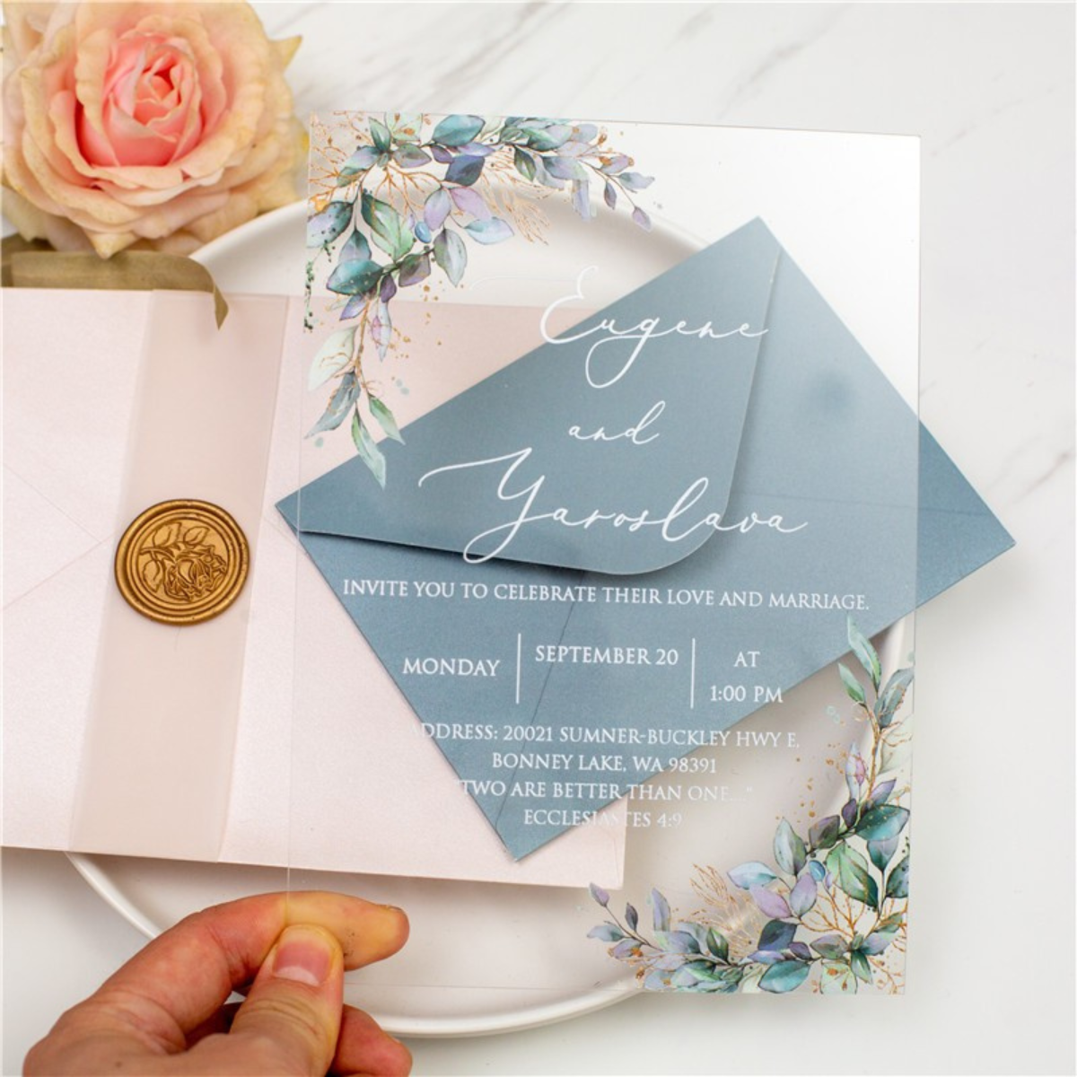 Clear acrylic wedding invitation with blue floral decorations