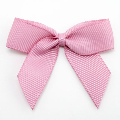 Antique Pink 5cm self-adhesive grosgrain ribbon bow on a white background