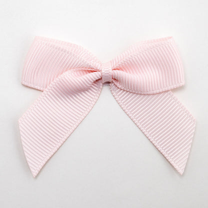 Blush Pink 5cm self-adhesive grosgrain ribbon bow on a white background