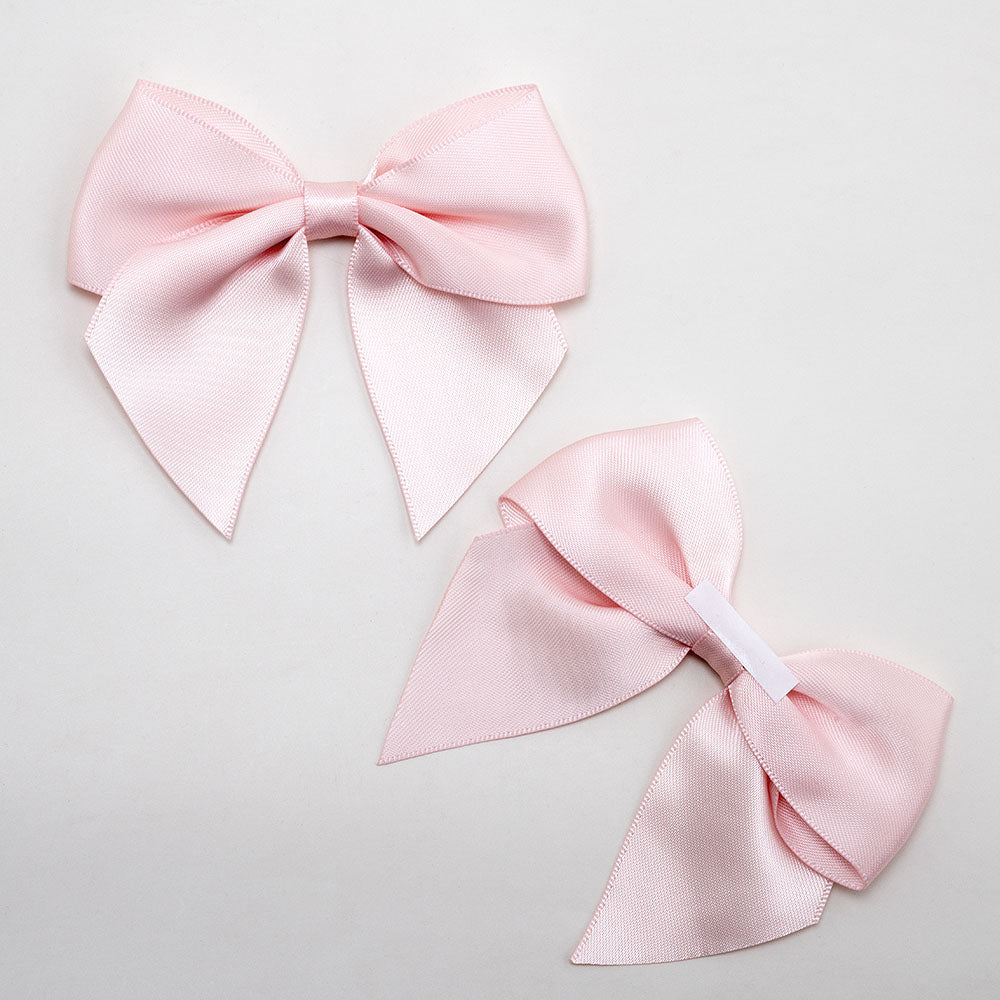 Front and back of blush pink 10cm satin gift bows showing the adhesive strip