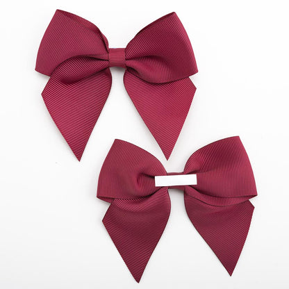 Front and back of burgundy 10cm grosgrain bow showing the self-adhesive strip
