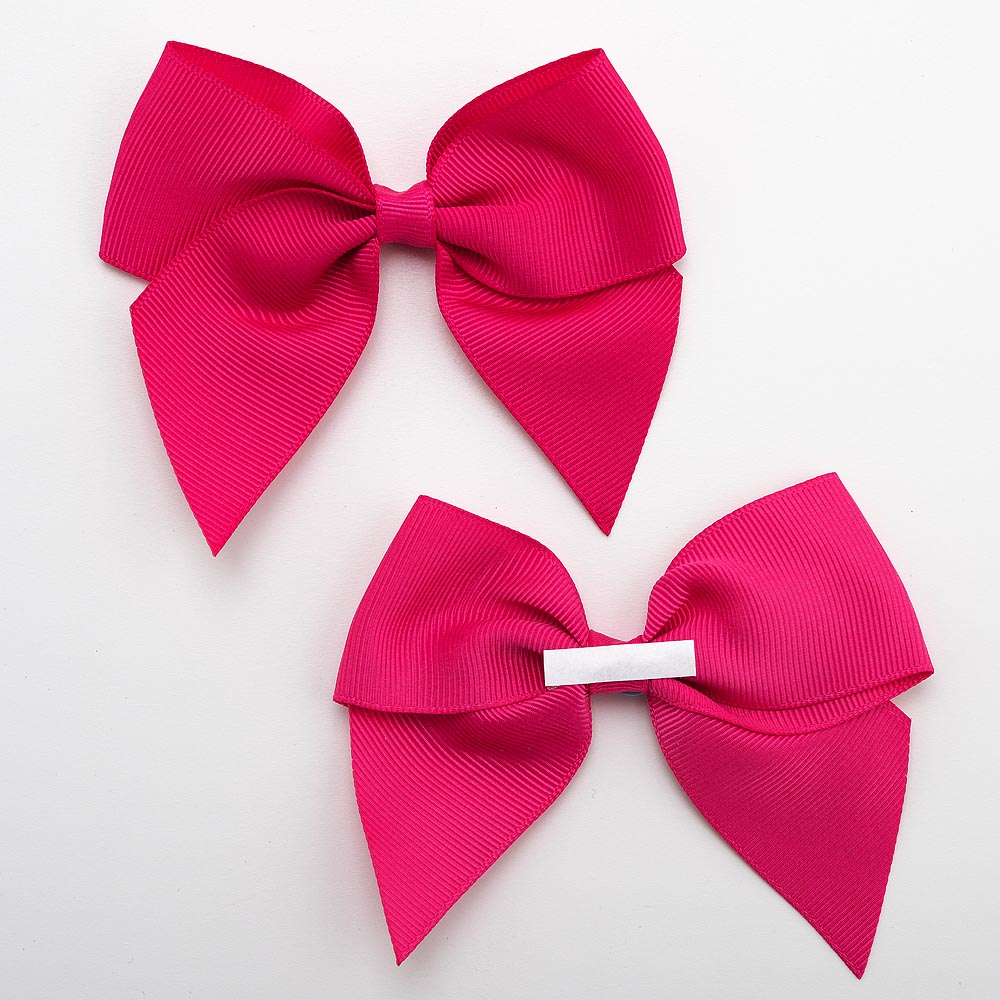 Front and back of cerise 10cm grosgrain bow showing the self-adhesive strip