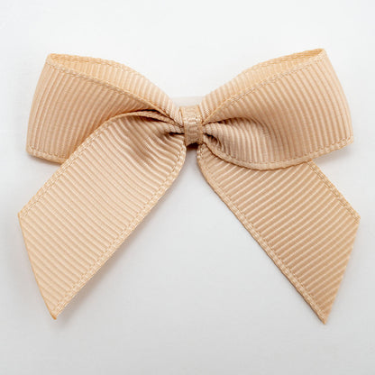 Champagne Gold 5cm self-adhesive grosgrain ribbon bow on a white background