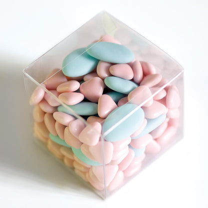 Clear 70mm cube wedding favour box filled with pink and blue sugared almonds