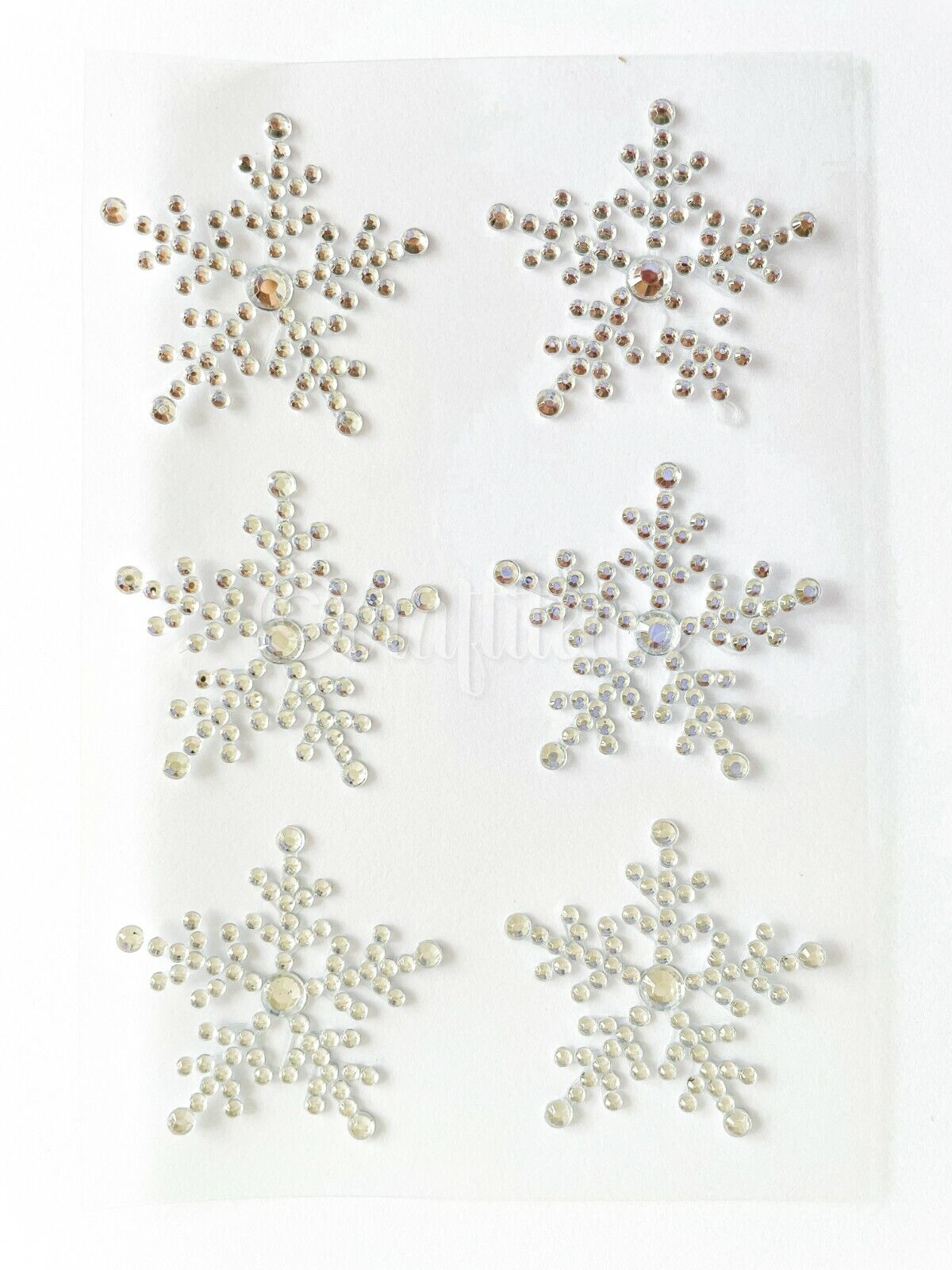Six self adhesive clear snowflake stickers on a sheet