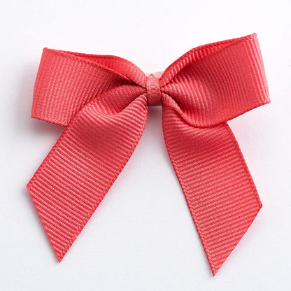 Coral 5cm self-adhesive grosgrain ribbon bow on a white background