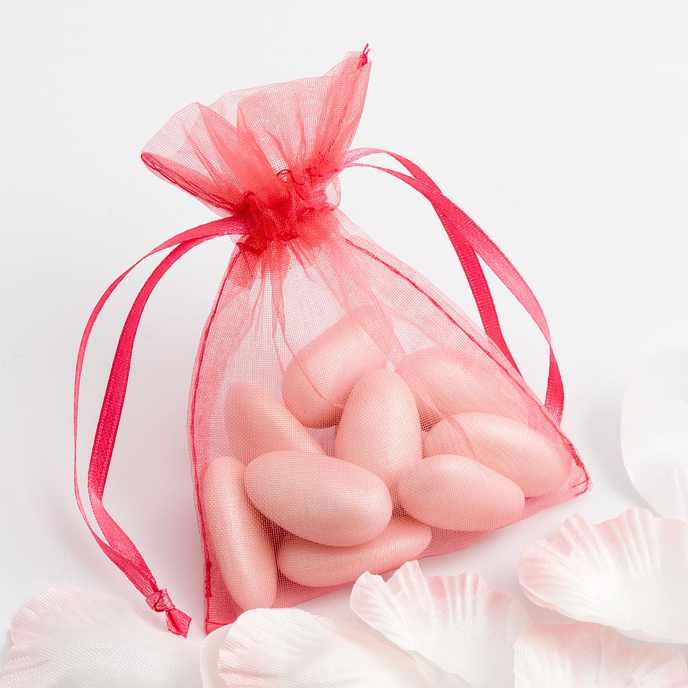 Coral organza wedding favour bag filled with sweets