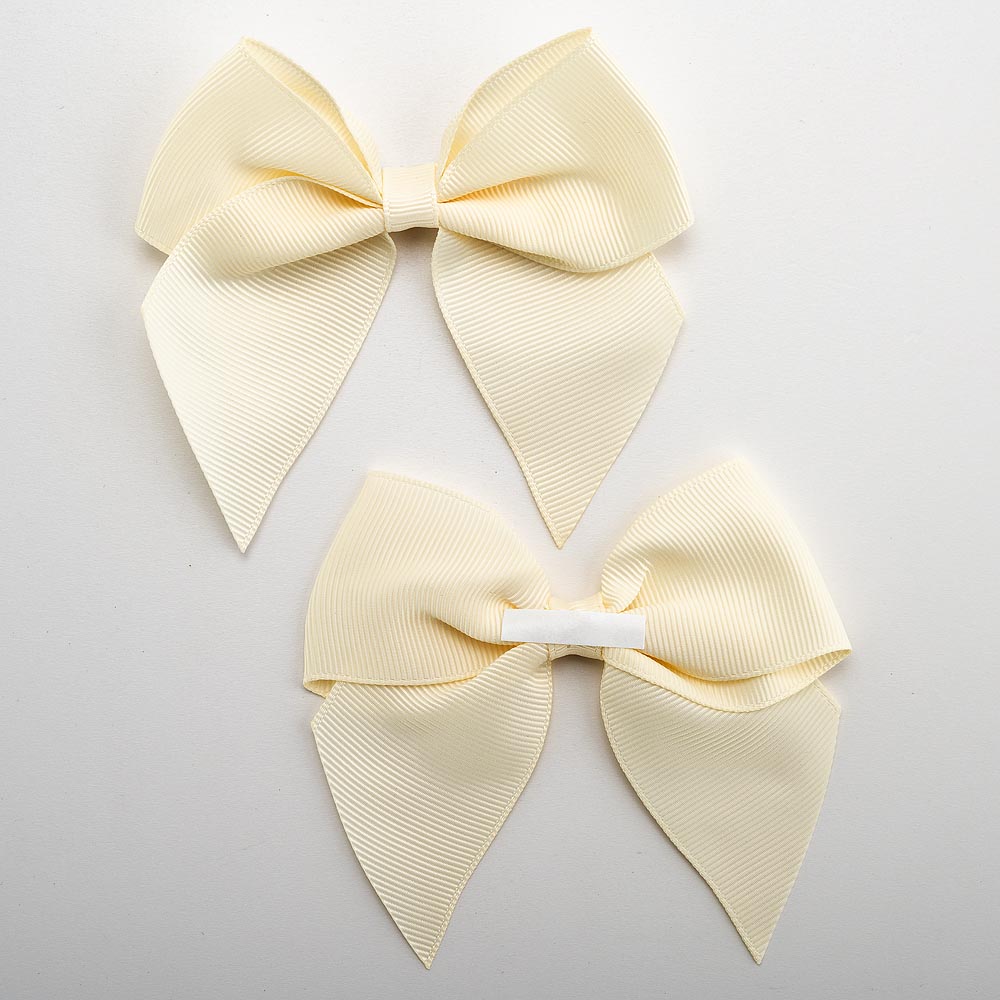 Front and back of cream 10cm grosgrain bow showing the self-adhesive strip