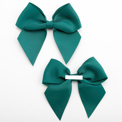 Front and back of dark green 10cm grosgrain bow showing the self-adhesive strip