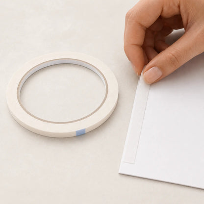 12mm double sided tape being applied to the back of card for invitation making
