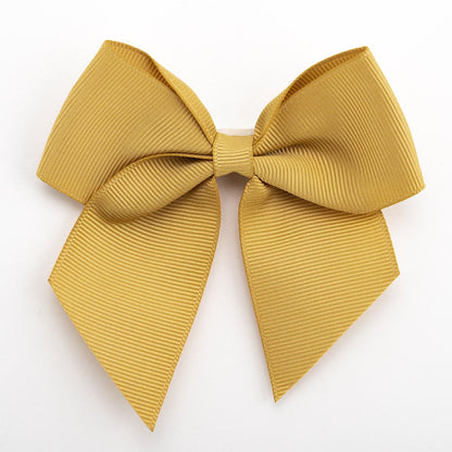 Gold 10cm self-adhesive grosgrain ribbon bow on a white background