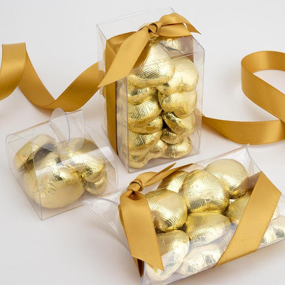 Gold chocolate heart wedding favours displayed in a gift box