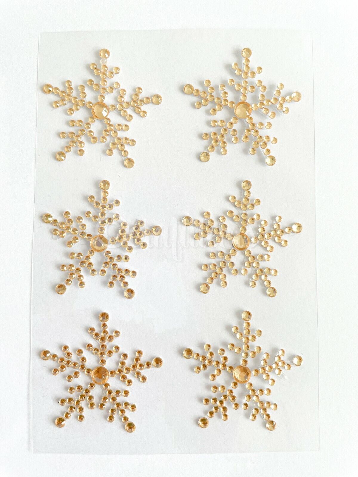 Gold snowflake gem stickers on a sheet