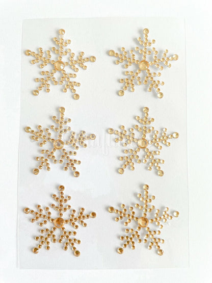 Gold snowflake gem stickers on a sheet