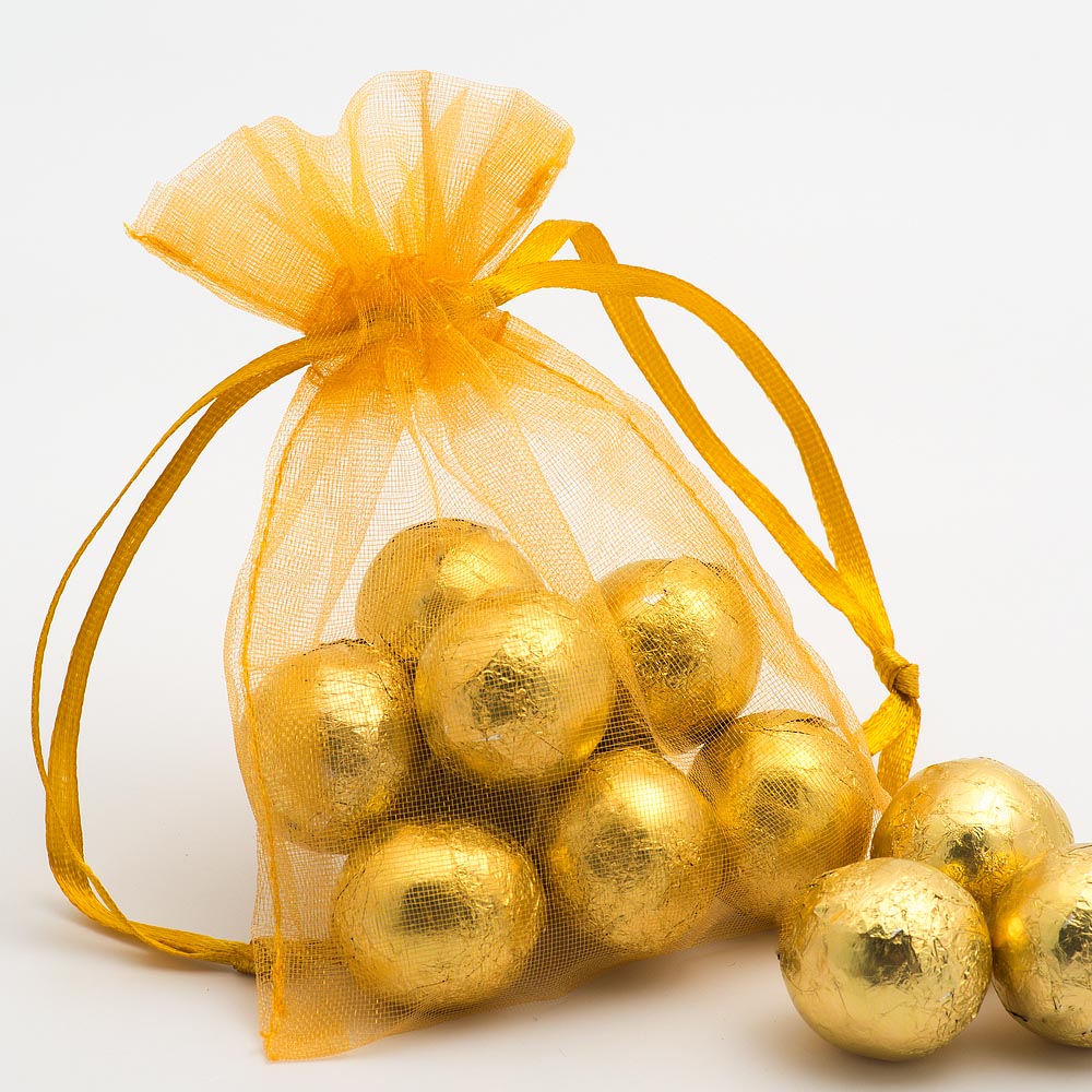 Gold organza wedding favour bag filled with sweets