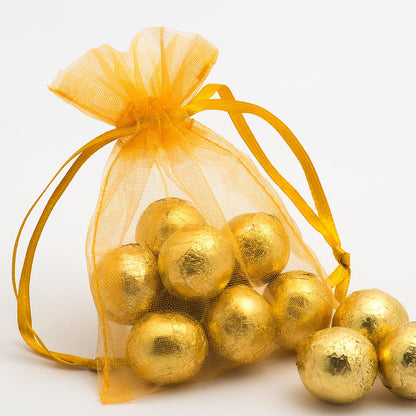 Gold organza wedding favour bag filled with sweets