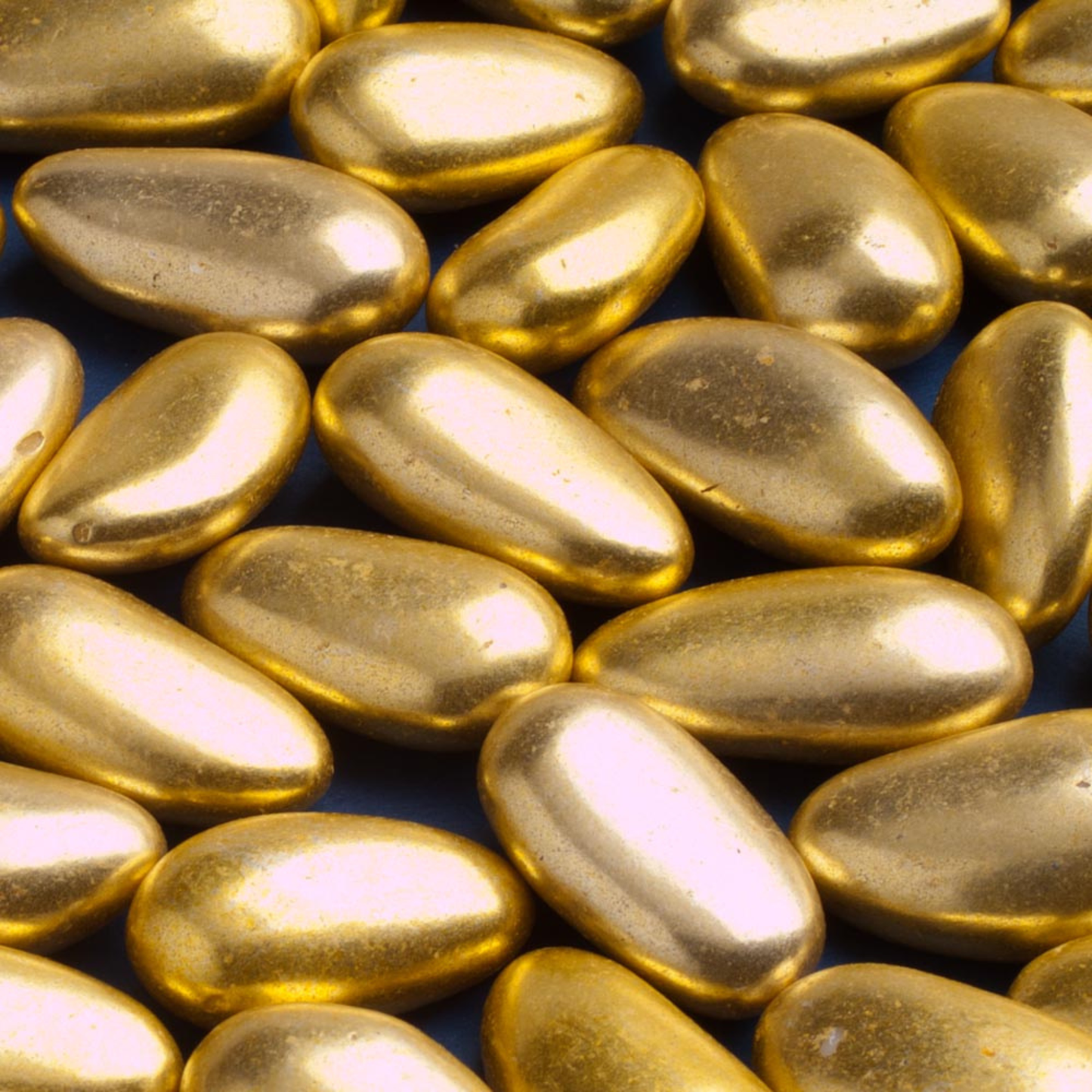 Close up of gold sugared almonds for wedding favours