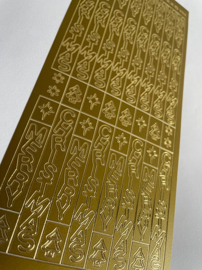 Close-up of gold vertical Merry Christmas greetings with trees and stars