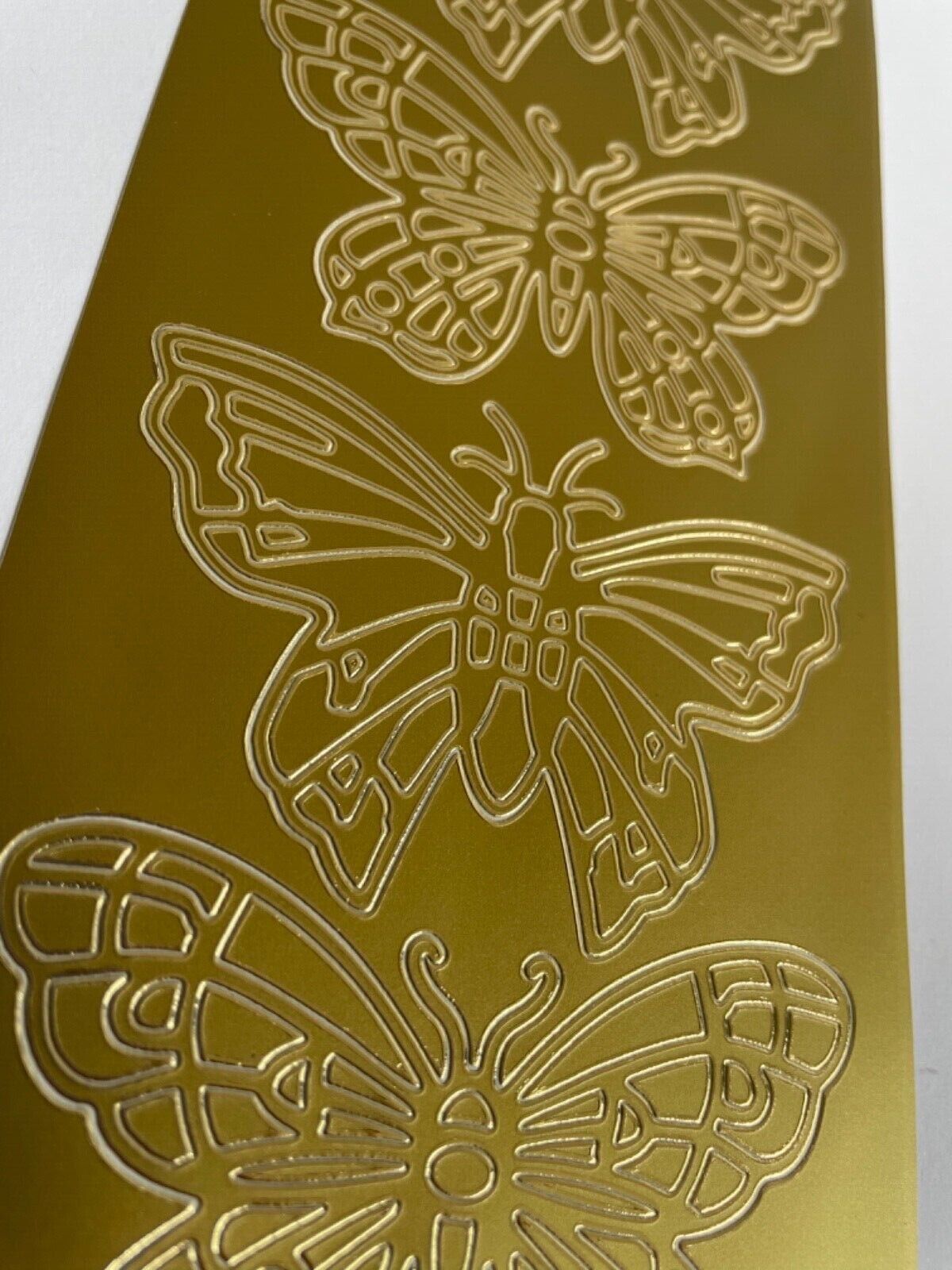Close up of large gold butterflies peel off sticker sheet