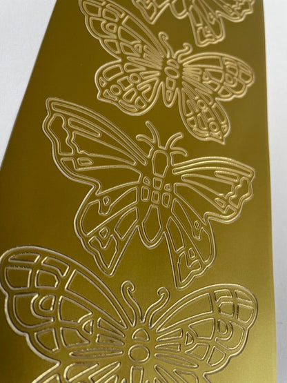Close up of large gold butterflies peel off sticker sheet