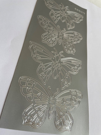 Close up of large silver butterflies peel off sticker sheet