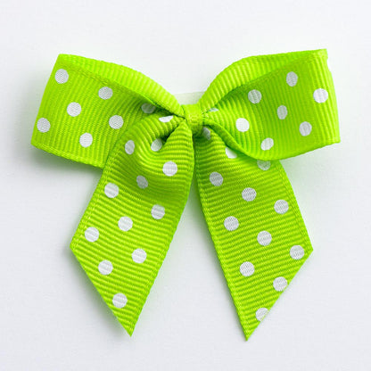 Lime 5cm polka dot grosgrain ribbon bow on a white background