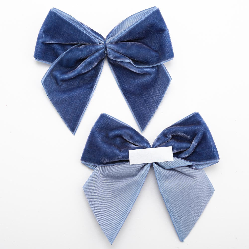 Front and back of navy 10cm velvet bows showing the self-adhesive strip