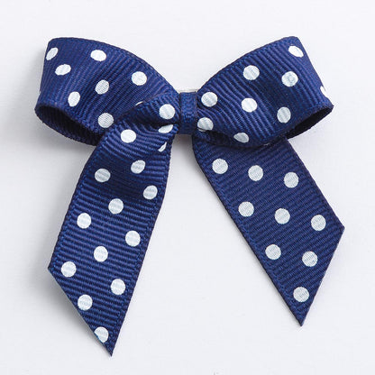 Navy 5cm polka dot grosgrain ribbon bow on a white background