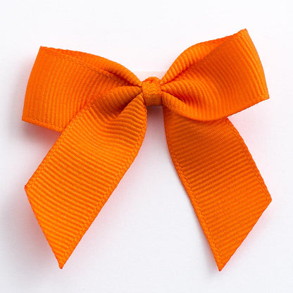 Orange 5cm self-adhesive grosgrain ribbon bow on a white background