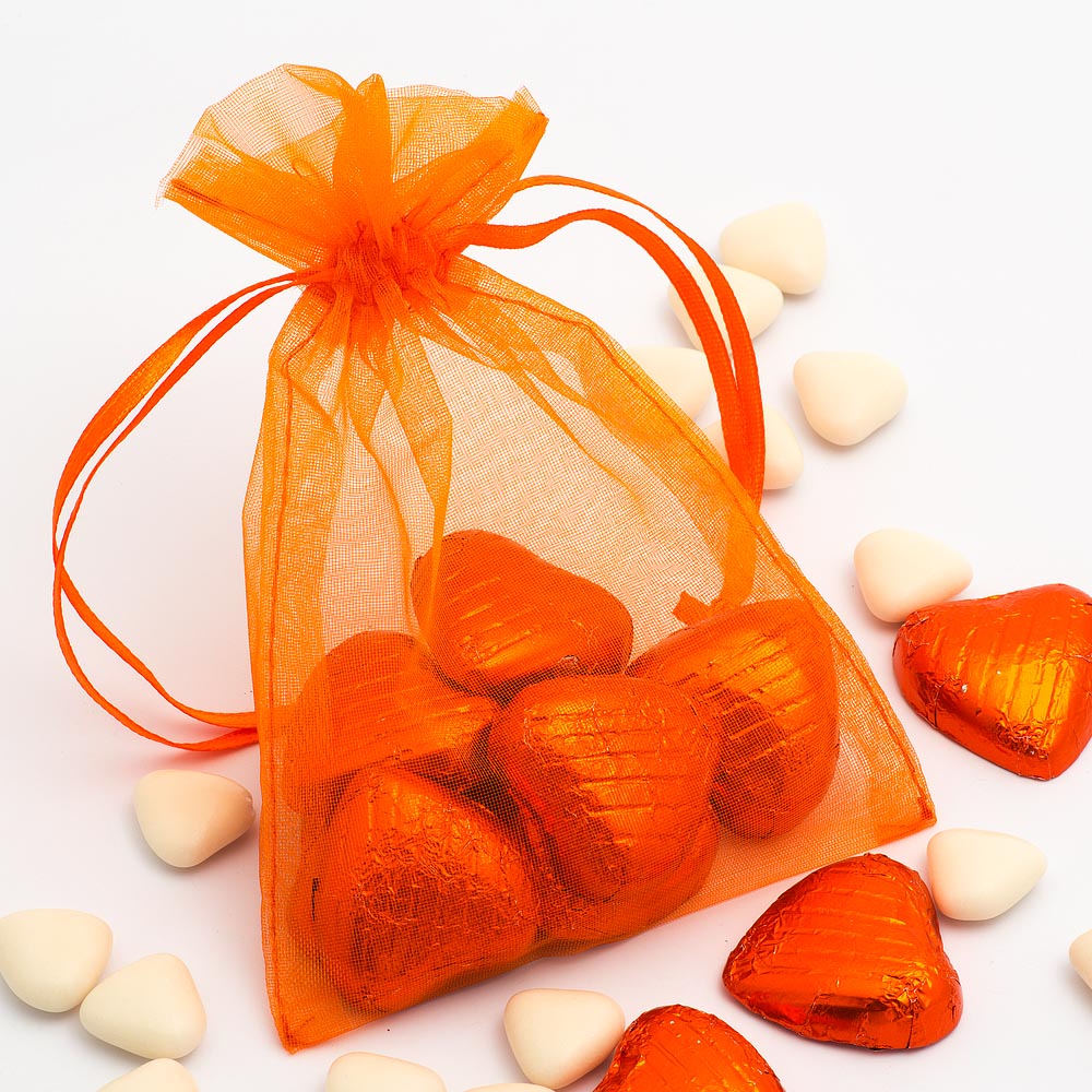 Orange organza wedding favour bag filled with sweets