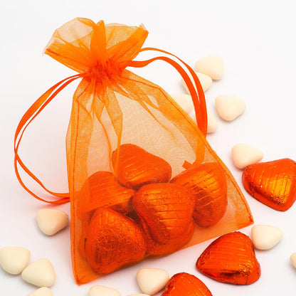 Orange organza wedding favour bag filled with sweets