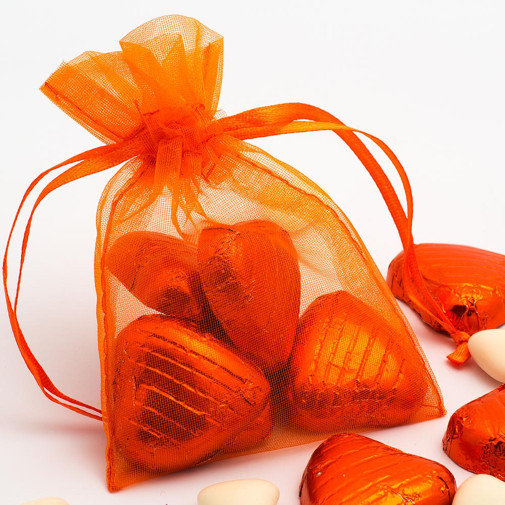 Orange organza wedding favour bag filled with sweets