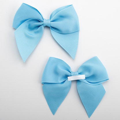 Front and back of pale blue 10cm grosgrain bow showing the self-adhesive strip