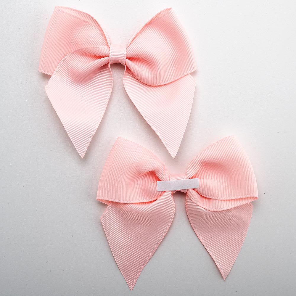 Front and back of pale pink 10cm grosgrain bow showing the self-adhesive strip