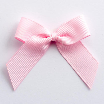 Pale Pink 5cm self-adhesive grosgrain ribbon bow on a white background