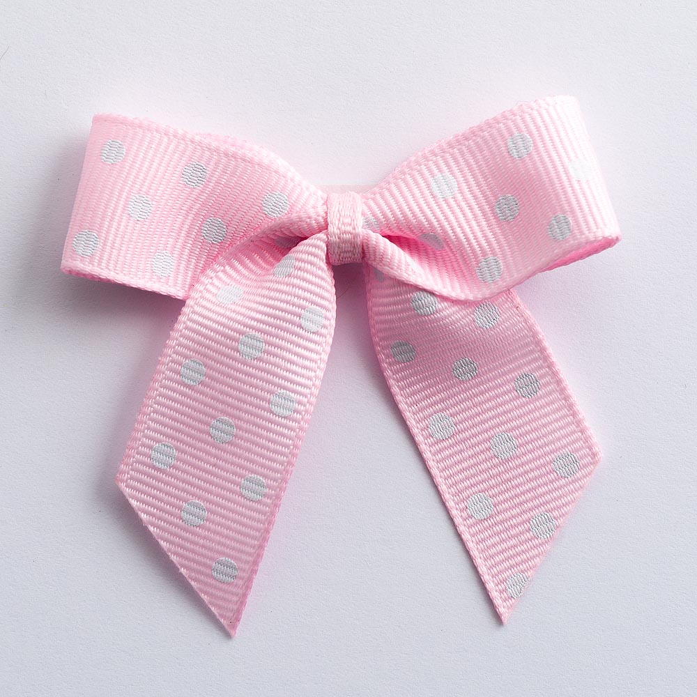 Pink 5cm polka dot grosgrain ribbon bow on a white background