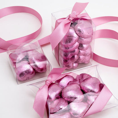 Pink chocolate heart wedding favours displayed in a gift box