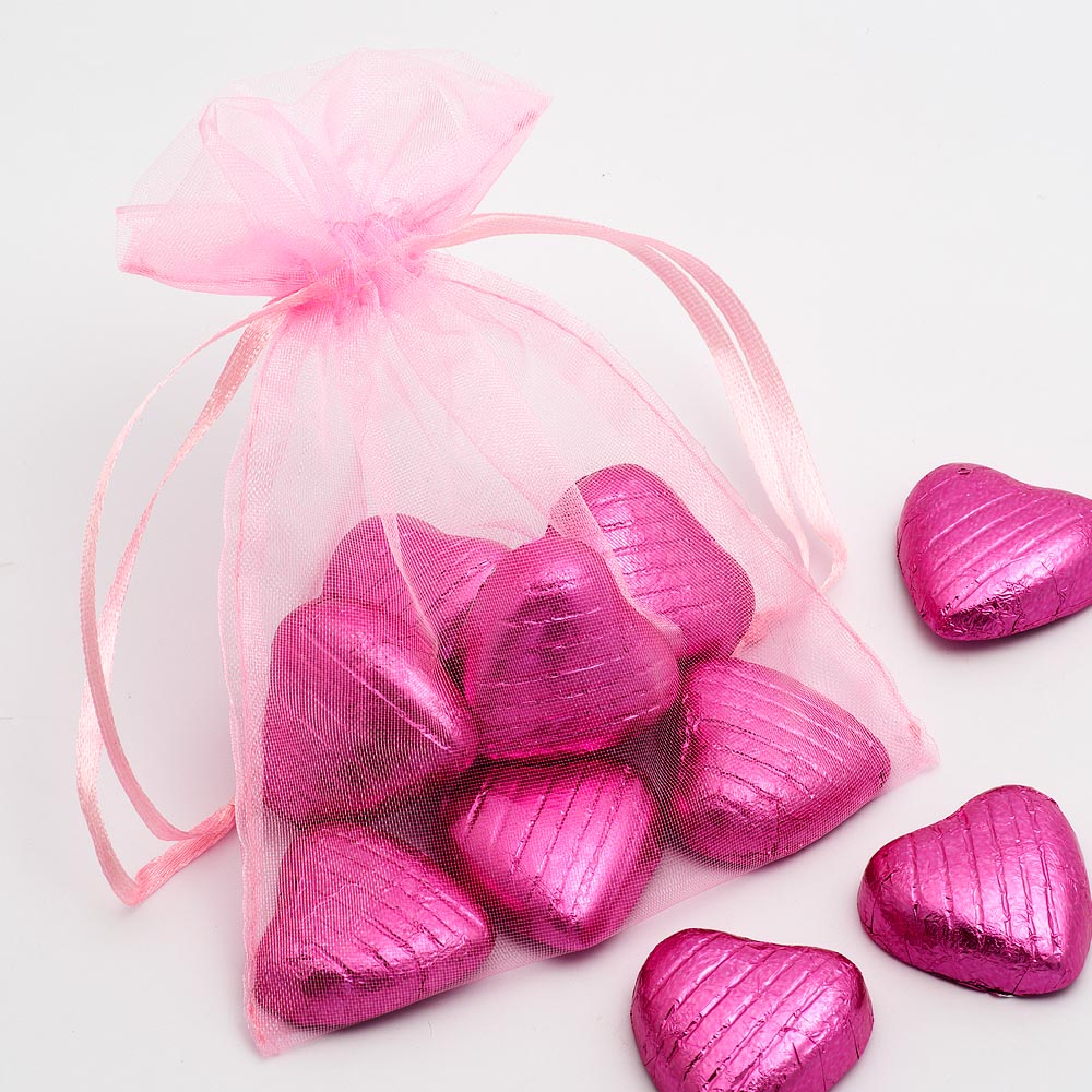 Pink organza wedding favour bag filled with sweets