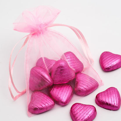 Pink organza wedding favour bag filled with sweets