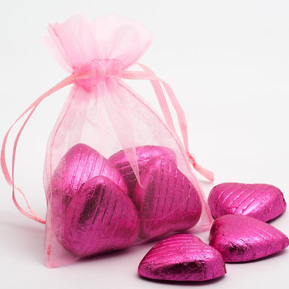 Pink organza wedding favour bag filled with sweets