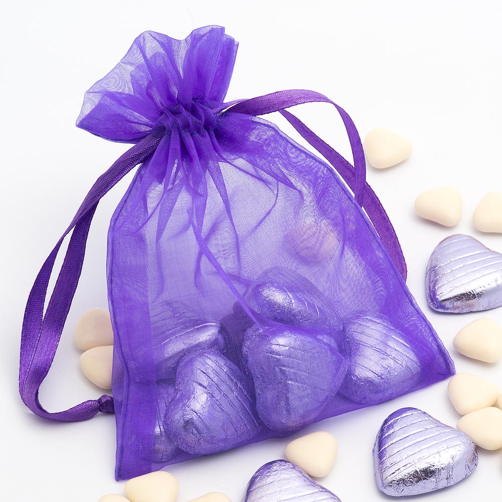 Purple organza wedding favour bag filled with sweets