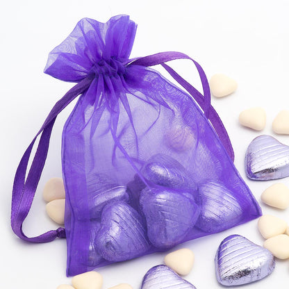 Purple organza wedding favour bag filled with sweets