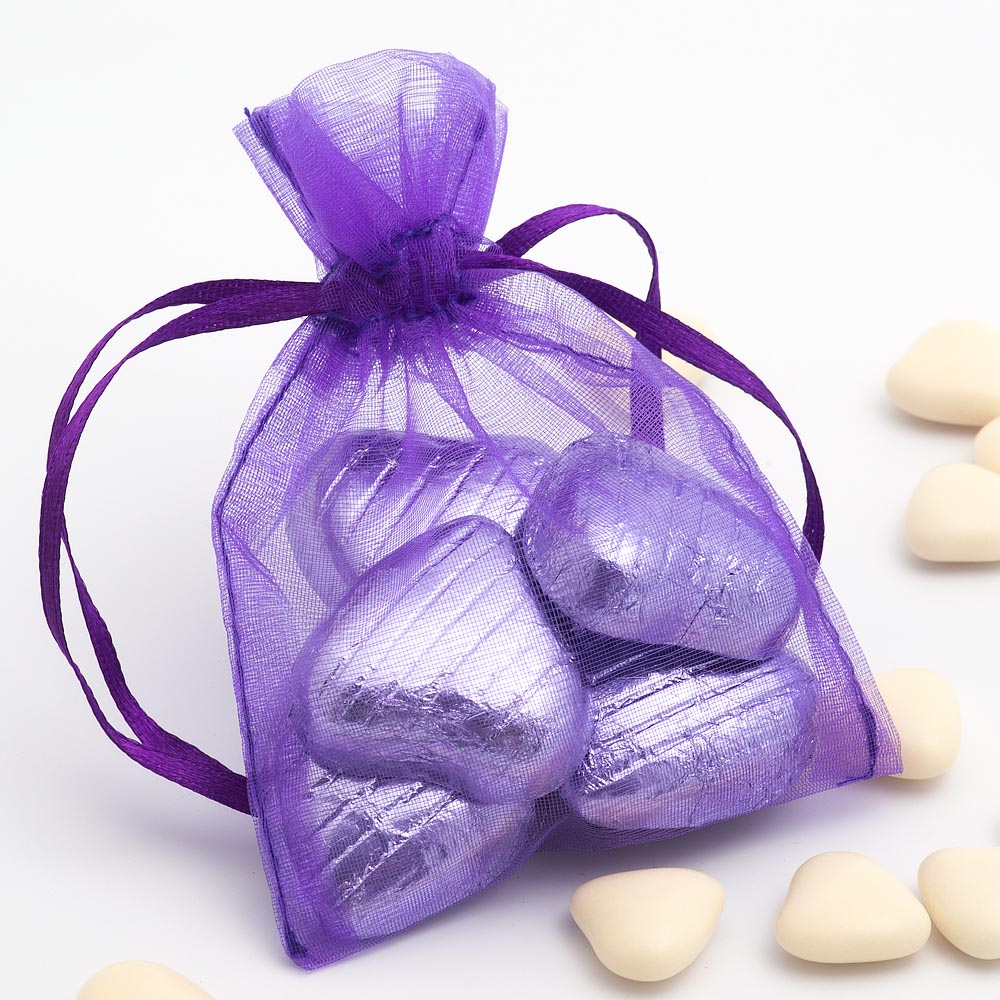 Purple organza wedding favour bag filled with sweets