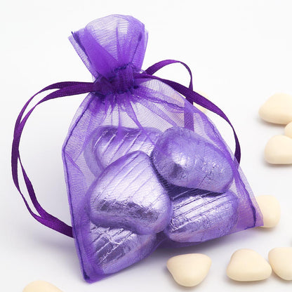 Purple organza wedding favour bag filled with sweets