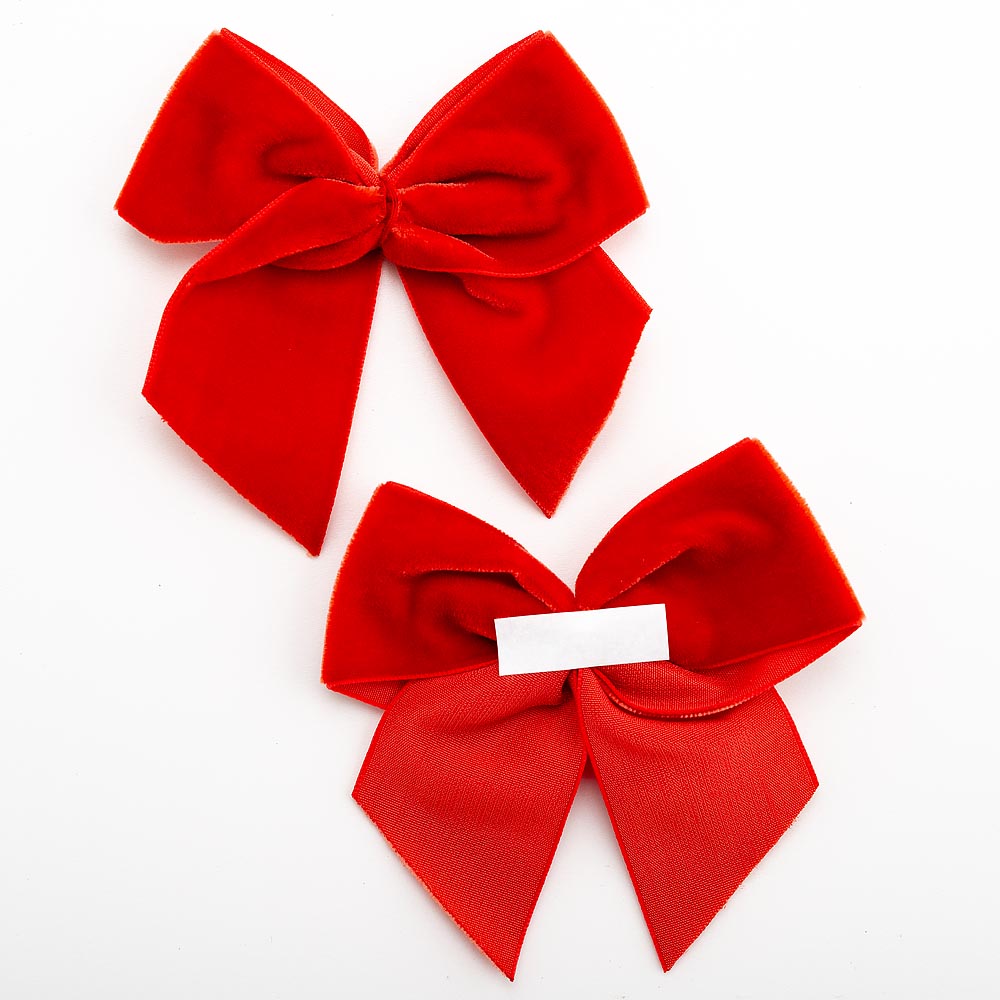 Front and back of red 10cm velvet bows showing the self-adhesive strip