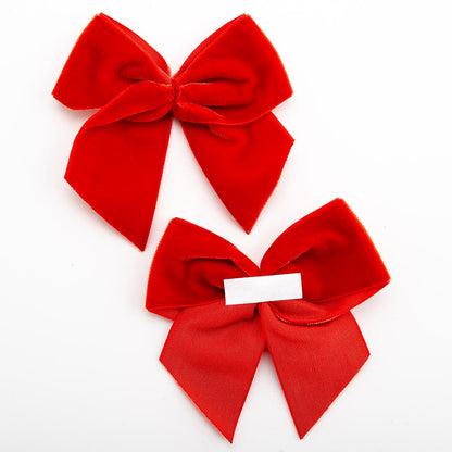 Front and back of red 10cm velvet bows showing the self-adhesive strip