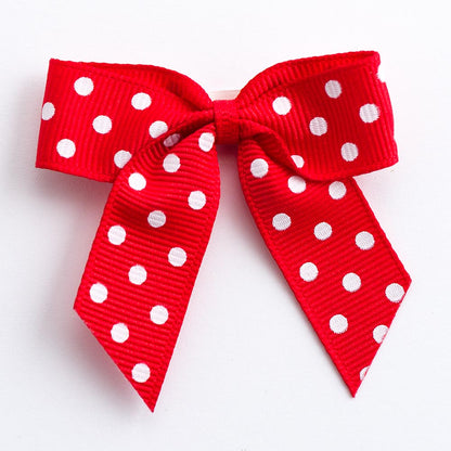 Red 5cm polka dot grosgrain ribbon bow on a white background