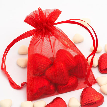 Red organza wedding favour bag filled with sweets